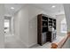 Hallway featuring a built-in bookcase with storage and decor, leading to other rooms in the home at 3708 Wesley Ridge Dr, Apex, NC 27539