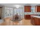 Bright eat-in kitchen features warm wood cabinetry, hardwood floors, and plantation shutters at 3708 Wesley Ridge Dr, Apex, NC 27539