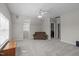 Spacious upstairs living area with comfortable seating and a door to a laundry room and additional storage at 3708 Wesley Ridge Dr, Apex, NC 27539