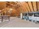 Unfinished attic space with exposed rafters offers potential for customization and expansion at 3715 Rawls Church Rd, Fuquay Varina, NC 27526