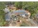 Aerial view of home featuring covered patio, playset, detached garage and lush surrounding greenery at 3715 Rawls Church Rd, Fuquay Varina, NC 27526