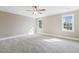 Bedroom features neutral walls, carpet and large windows that provide lots of natural light at 3715 Rawls Church Rd, Fuquay Varina, NC 27526