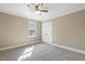 Bedroom with neutral carpet, a window, and double-door closet at 3715 Rawls Church Rd, Fuquay Varina, NC 27526