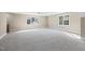Large bonus room with neutral carpet and lots of natural light at 3715 Rawls Church Rd, Fuquay Varina, NC 27526