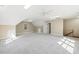 Large bonus room with neutral carpet, large windows, and stairs at 3715 Rawls Church Rd, Fuquay Varina, NC 27526