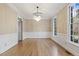 Dining room with hardwood floors, wainscoting, a chandelier and large windows at 3715 Rawls Church Rd, Fuquay Varina, NC 27526