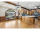 Open concept kitchen with hardwood floors, wood cabinets, and a large arched window at 3715 Rawls Church Rd, Fuquay Varina, NC 27526