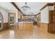 Open concept kitchen features wood cabinets, stainless steel appliances and a chandelier at 3715 Rawls Church Rd, Fuquay Varina, NC 27526
