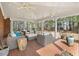 Covered patio area features brick flooring, ceiling fans, and wicker furniture at 3715 Rawls Church Rd, Fuquay Varina, NC 27526
