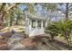 Outdoor shed provides additional storage space, complemented by a stone walkway and manicured yard at 3715 Rawls Church Rd, Fuquay Varina, NC 27526