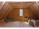 Unfinished attic space displaying exposed studs, a window and storage with potential at 3901 Laurel Creek Ln, Wake Forest, NC 27587