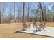 Backyard patio featuring Adirondack chairs offers a serene view of the surrounding trees at 3901 Laurel Creek Ln, Wake Forest, NC 27587