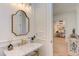 Bathroom vanity area featuring a marble countertop, gold fixtures, and decorative mirror at 3901 Laurel Creek Ln, Wake Forest, NC 27587