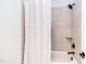 Clean, bright bathroom featuring a tile shower, shower head, and white shower curtain at 3901 Laurel Creek Ln, Wake Forest, NC 27587
