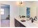 Bathroom featuring double sinks, black hardware, and natural light at 3901 Laurel Creek Ln, Wake Forest, NC 27587