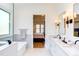Spacious, bright bathroom features double vanity, soaking tub, and access to the main bedroom at 3901 Laurel Creek Ln, Wake Forest, NC 27587