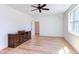 Bright bedroom featuring a ceiling fan, large window, and beautiful hardwood floors at 3901 Laurel Creek Ln, Wake Forest, NC 27587
