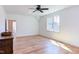 Bright bedroom featuring a ceiling fan, large window, and beautiful hardwood floors at 3901 Laurel Creek Ln, Wake Forest, NC 27587