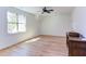 Bright bedroom featuring a ceiling fan, large window, and beautiful hardwood floors at 3901 Laurel Creek Ln, Wake Forest, NC 27587