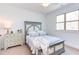 Bright bedroom offers a large window and dresser at 3901 Laurel Creek Ln, Wake Forest, NC 27587