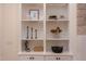 Close up of the built-in shelving featuring decorative vases, candles, and framed photos at 3901 Laurel Creek Ln, Wake Forest, NC 27587
