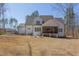 Charming exterior view of the home showcasing a spacious backyard and covered patio at 3901 Laurel Creek Ln, Wake Forest, NC 27587