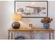 Close-up showcasing a decorative table with a lamp, flowers, and a framed picture in the entryway at 3901 Laurel Creek Ln, Wake Forest, NC 27587
