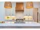 Well-appointed kitchen boasts white cabinetry, granite counters, and a stainless steel gas range at 3901 Laurel Creek Ln, Wake Forest, NC 27587