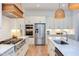 Bright kitchen featuring stainless steel appliances, a marble island, and custom wood accents at 3901 Laurel Creek Ln, Wake Forest, NC 27587