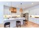 Modern kitchen featuring a marble island, white cabinets, and stainless steel appliances at 3901 Laurel Creek Ln, Wake Forest, NC 27587