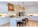 Gourmet kitchen showcasing white cabinets, stainless appliances, and a large island with bar seating at 3901 Laurel Creek Ln, Wake Forest, NC 27587