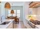 Eat-in kitchen with marble countertops, stainless appliances, and adjacent dining area at 3901 Laurel Creek Ln, Wake Forest, NC 27587