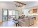 Open concept living room featuring hardwood floors, comfortable seating, and access to a screened porch at 3901 Laurel Creek Ln, Wake Forest, NC 27587