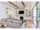 Spacious living room featuring a stone fireplace, built-in shelving, and a seamless transition to the outdoor patio at 3901 Laurel Creek Ln, Wake Forest, NC 27587