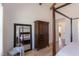 Well-appointed main bedroom features a large armoire, mirror, and entry to the main bathroom at 3901 Laurel Creek Ln, Wake Forest, NC 27587