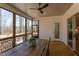 Inviting screened porch with wood floors, a ceiling fan, and peaceful views of the wooded backyard at 3901 Laurel Creek Ln, Wake Forest, NC 27587
