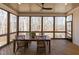 Screened-in porch features a wood table, seating, ceiling fan, and a private view at 3901 Laurel Creek Ln, Wake Forest, NC 27587
