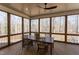 Screened-in porch features a wood table, seating, ceiling fan, and a private view at 3901 Laurel Creek Ln, Wake Forest, NC 27587