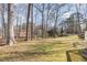 Spacious backyard featuring mature trees and a large grassy area at 4508 Regis Ave, Durham, NC 27705