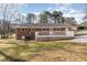 Back of the home features a brick exterior, a deck, and a spacious backyard at 4508 Regis Ave, Durham, NC 27705