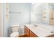 Bathroom with light blue walls, wood cabinets, and white sink at 4508 Regis Ave, Durham, NC 27705