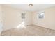 Bright, carpeted bedroom featuring neutral walls and natural light from two windows at 4508 Regis Ave, Durham, NC 27705