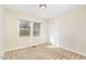 Bright bedroom features neutral walls, carpet, a window, and closet at 4508 Regis Ave, Durham, NC 27705