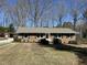 Charming brick home with a manicured front yard and a red shed in the background at 4508 Regis Ave, Durham, NC 27705
