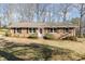 Charming brick ranch home with black shutters and landscaped front yard at 4508 Regis Ave, Durham, NC 27705