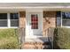 The front entrance of the brick home features a red door and black address numbers at 4508 Regis Ave, Durham, NC 27705