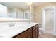 Bathroom featuring a double sink vanity, large mirror, and a view to a closet area at 5315 Glenmorgan Ln, Raleigh, NC 27616