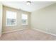 Empty bedroom features carpet flooring and two windows, offering a clean canvas for personalization at 5315 Glenmorgan Ln, Raleigh, NC 27616