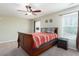 Bedroom featuring a wooden bed, a ceiling fan, carpet, and natural light from two windows at 5315 Glenmorgan Ln, Raleigh, NC 27616