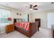 Bedroom featuring a wooden bed, a ceiling fan, carpet, and natural light from two windows at 5315 Glenmorgan Ln, Raleigh, NC 27616